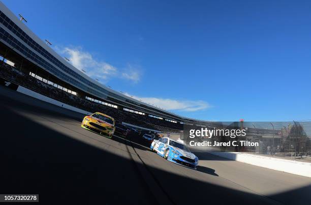 Ryan Blaney, driver of the Accella/Carlisle Ford, and Clint Bowyer, driver of the Rush Truck Centers/Mobil Delvac 1 Ford, lead the field under...
