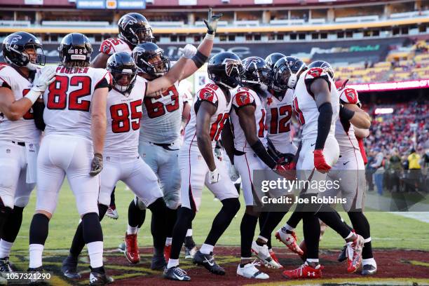 Julio Jones of the Atlanta Falcons is mobbed by teammates after catching a 35-yard touchdown pass in the fourth quarter of the game against the...