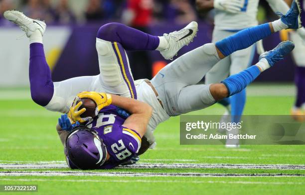 Kyle Rudolph of the Minnesota Vikings is tackled with the ball in the fourth quarter of the game against the Detroit Lions at U.S. Bank Stadium on...