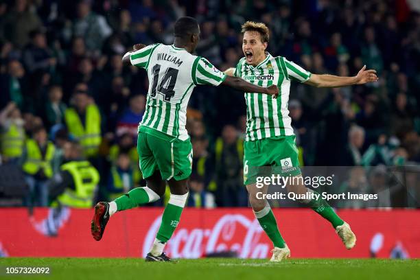 Sergio Canales of Real Betis celebrates after scoring his team's third goal with his teammate William Carvalho during the La Liga match between Real...