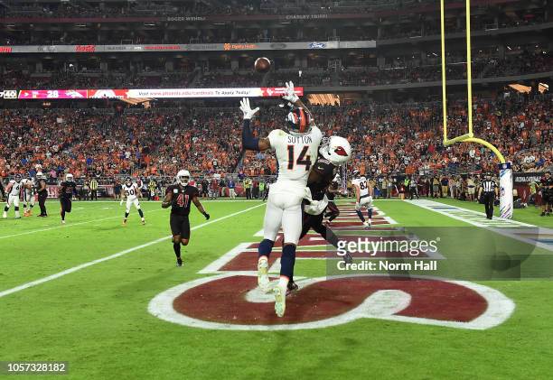 Courtland Sutton of the Denver Broncos attempts to make a leaping catch in the endzone while being defended by Bene Benwikere of the Arizona...