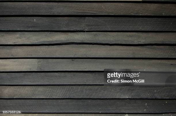 weathered timber planks on the exterior of a boat shed - tool shed wall spaces stockfoto's en -beelden