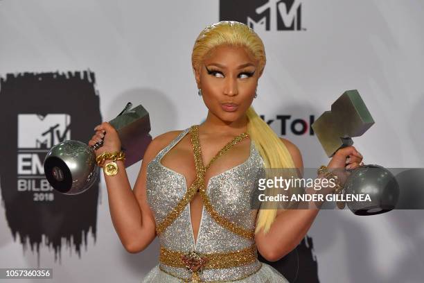 Trinidadian-US rapper Nicki Minaj poses backstage with her awards during the MTV Europe Music Awards at the Bizkaia Arena in the northern Spanish...