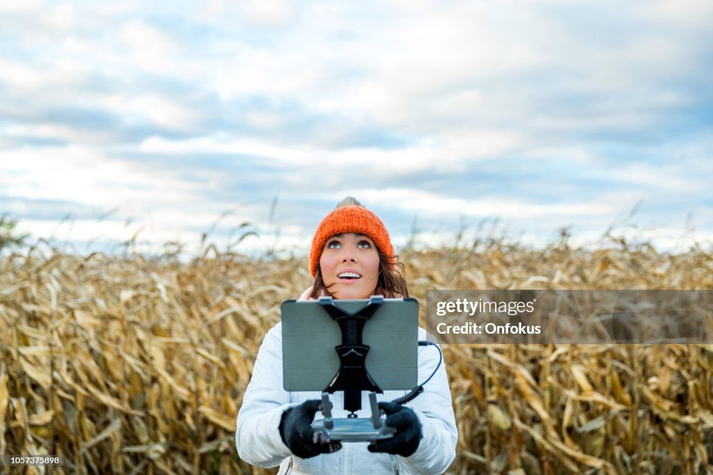 Donna pilota utilizzando telecomando drone con un montaggio tablet