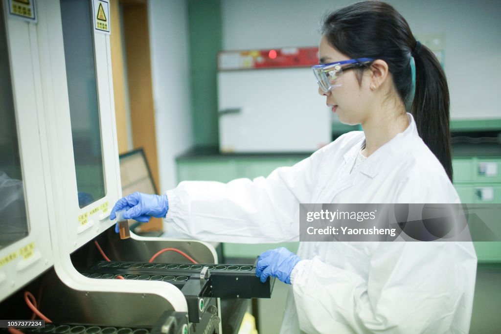 Beautiful asian female chemist study the engine oil formulation in the lab,shanghai,china