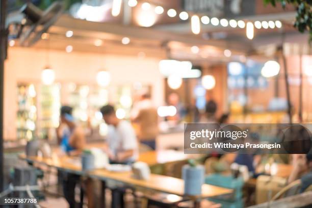 blurred background of restaurant with people. - busy cafe fotografías e imágenes de stock