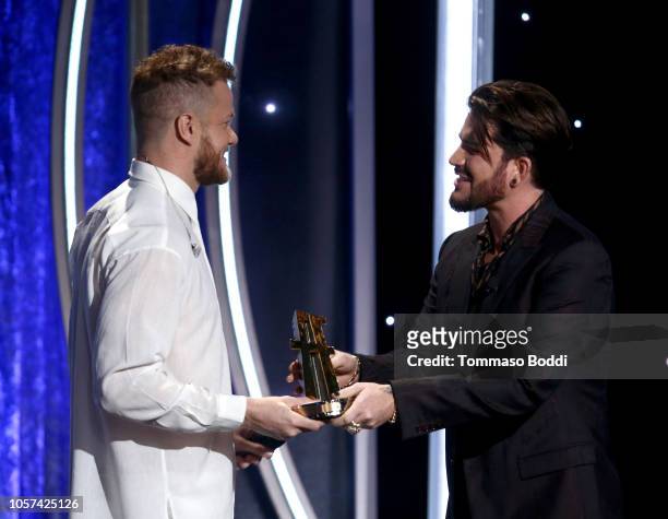 Dan Reynolds accepts the Hollywood Documentary Award for "Believer" from Adam Lambert onstage during the 22nd Annual Hollywood Film Awards at The...