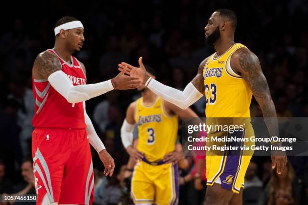 Carmelo Anthony of the Houston Rockets shakes hands with his good friend LeBron James of the Los Angeles Lakers after the Lakers' home opener against...