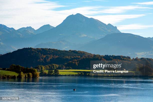 "lac de la gruyère" (french for gruyere lake) with view of moleson mountain (2002 m / 6000ft), town of bulle-fribourg, switzerland nearby - fribourg canton stock pictures, royalty-free photos & images