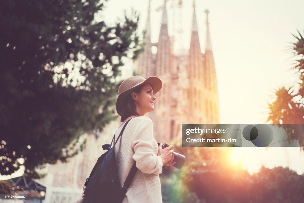 Tourist woman with camera exploring Bracelona