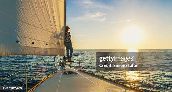 Woman staying on edge of prow, Croatia Woman staying on edge of prow, Croatia