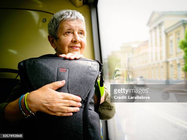 senior woman traveling by bus - old woman by window stock pictures, royalty-free photos & images