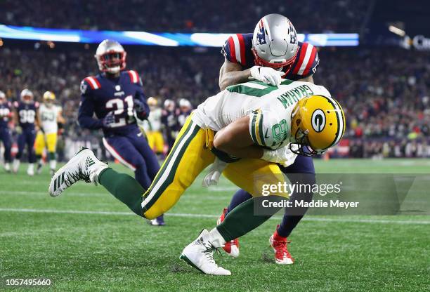 Jimmy Graham of the Green Bay Packers catches a touchdown pass against Patrick Chung of the New England Patriots during the third quarter at Gillette...