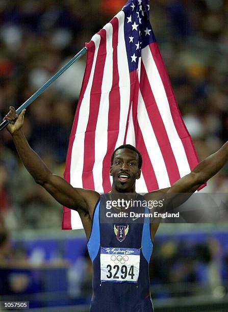 Michael Johnson of USA celebrates after winning Gold in the Men's 400m final at the Sydney 2000 Olympic Games, Sydney Australia. DIGITAL IMAGE....