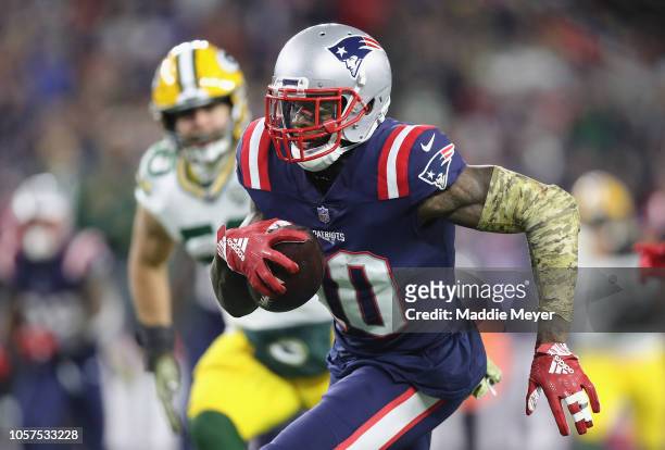 Josh Gordon of the New England Patriots runs with the ball on his way to scoring a 55-yard receiving touchdown during the fourth quarter against the...