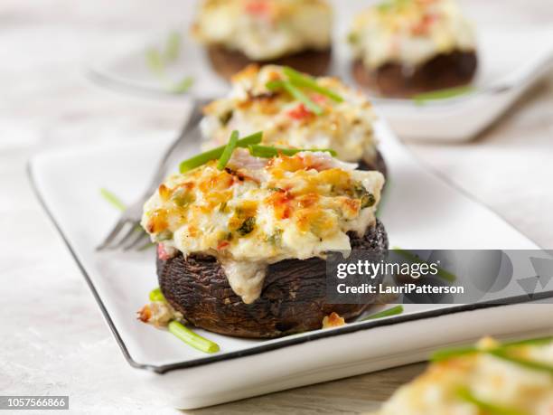 creamy, crab and shrimp stuffed mini portobello mushroom caps - toadstool stock pictures, royalty-free photos & images