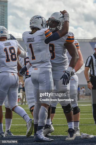 Miners quarterback Kai Locksley celebrates with teammates following his rushing touchdown during the football game between the UTEP Miners and the...