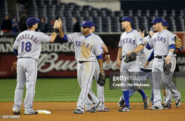 Mitch Moreland, Nelson Cruz, David Murphy and Josh Hamilton of the Texas Rangers celebrate after the Rangers won 10-3 against the New York Yankees in...