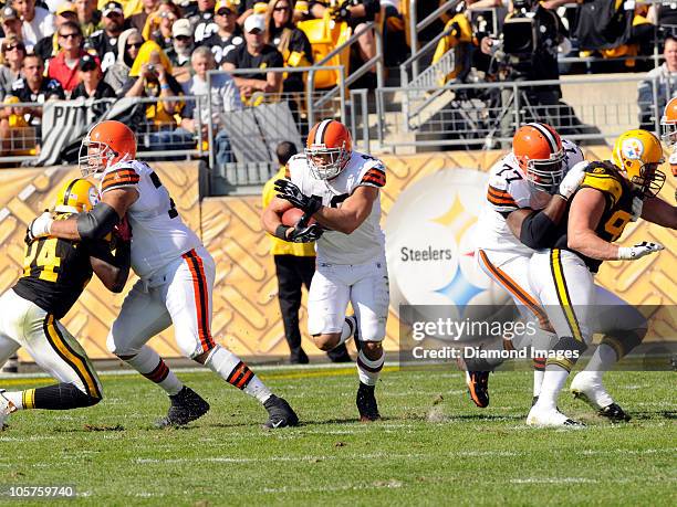 Running back Peyton Hillis of the Cleveland Browns carries the ball through a hole opened by lineman Tony Pashos and Floyd Womack during a game with...