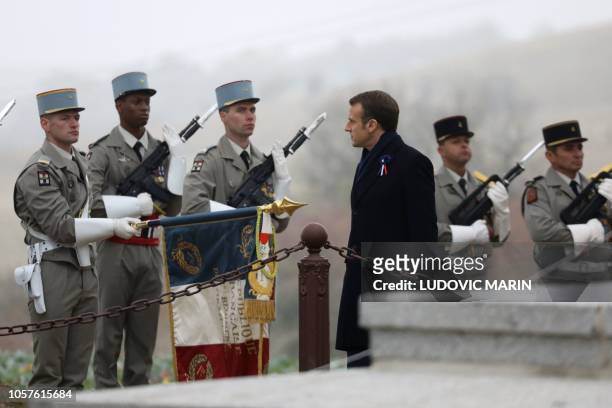 French President Emmanuel Macron reviews a military honour guard as he attends a ceremony in tribute to the French soldiers killed in August 1914...