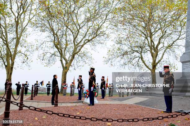 French President Emmanuel Macron lays flowers in tribute to the French soldiers killed in August 1914 during border battles, at the War memorial in...