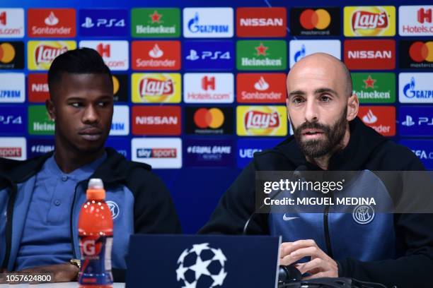 Inter Milan's Spanish midfielder Borja Valero speaks as Inter Milan's Senegalese forward Keita Balde looks on during a press conference on November...