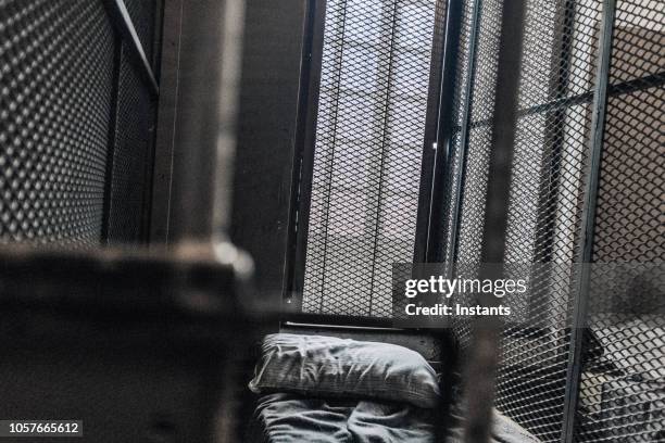 glimpse at an old jail cell interior. - violent crime stock pictures, royalty-free photos & images