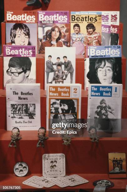 Beatles memorabilia on display including Beatles news books issued by the fan club, plastic figures of Paul, Ringo George and John and beer mats,...