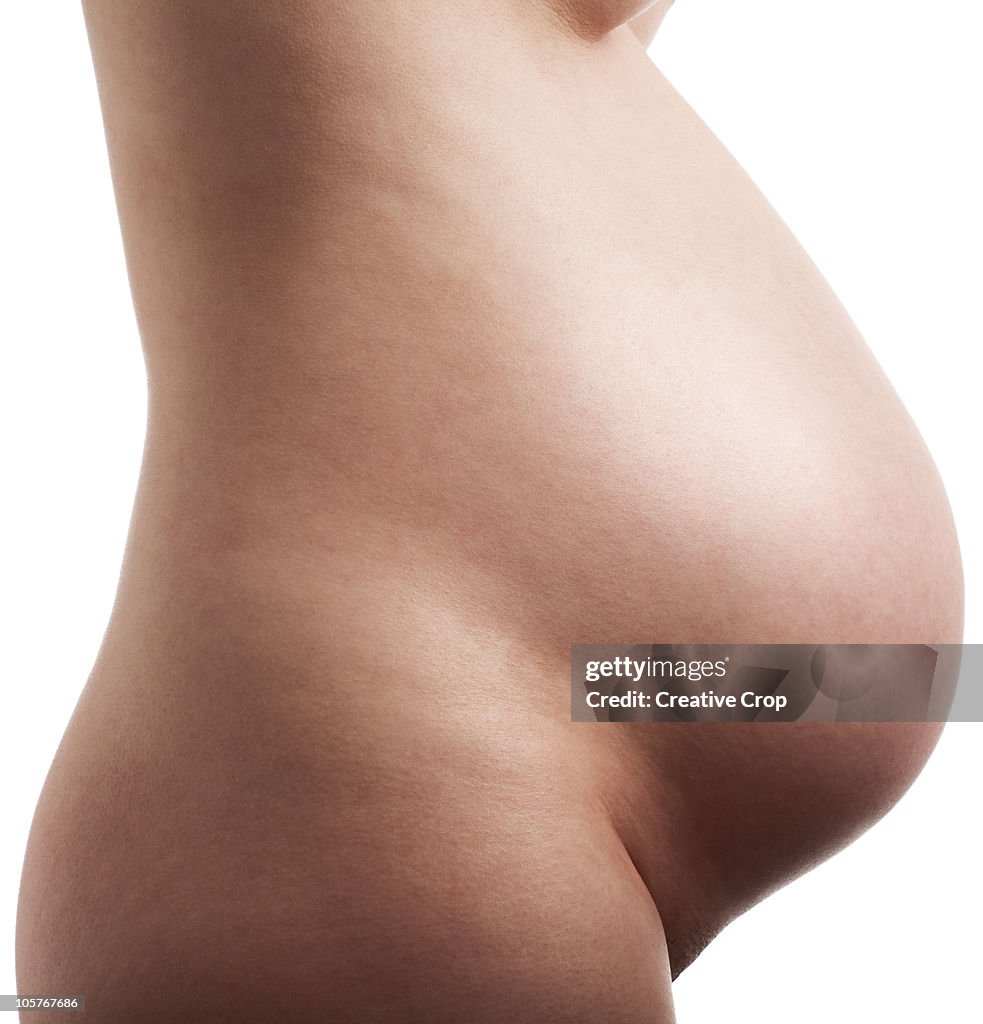 Woman's pregnant belly, side view