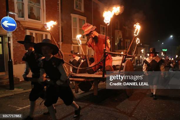 Guy is paraded through the streets of Lewes in East Sussex, southern England, on November 5 during the traditional Bonfire Night celebrations. -...