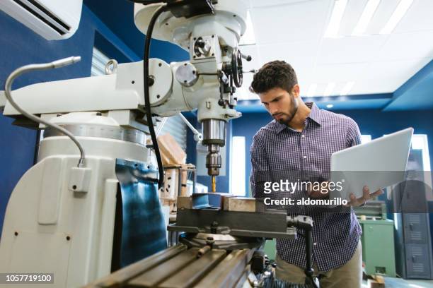young latin engineer calibrating drill - engineer stock pictures, royalty-free photos & images
