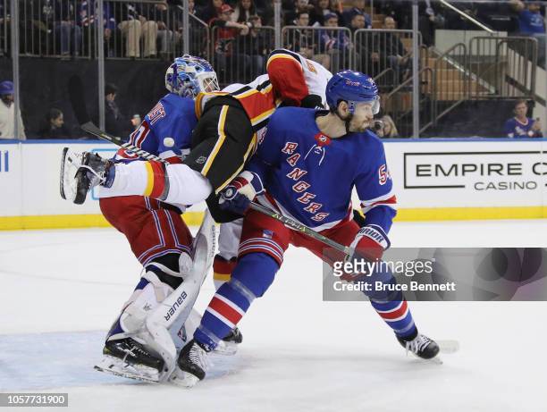 Henrik Lundqvist and Adam McQuaid of the New York Rangers defend against Matthew Tkachuk of the Calgary Flames during the first period at Madison...