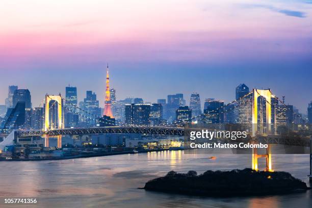 rainbow bridge and skyline at sunset, tokyo, japan - japan cityscape stock pictures, royalty-free photos & images
