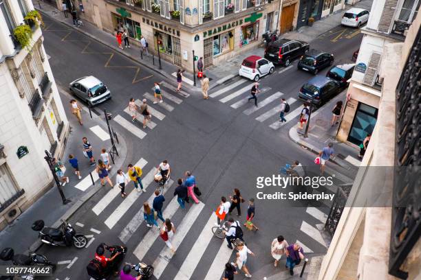 pedestrian crossing at street intersection in paris - pedestrian car stock pictures, royalty-free photos & images