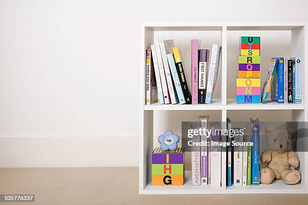 book shelves with books and toys - bookshelf foto e immagini stock