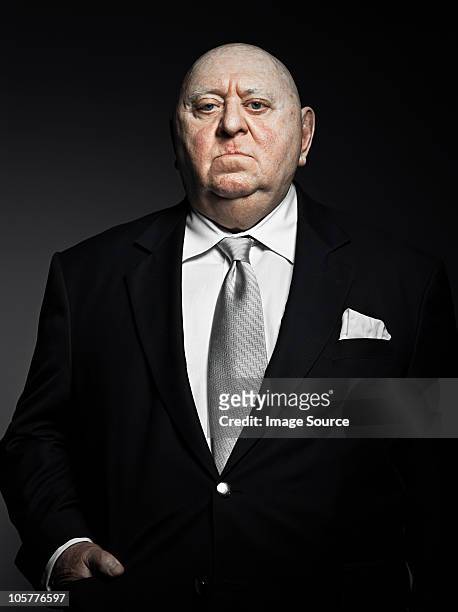 studio portrait of serious gangster - fat man in suit stock pictures, royalty-free photos & images