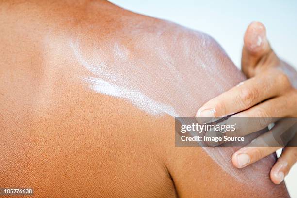 woman applying sunscreen, maldives - crema solare foto e immagini stock