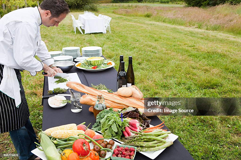 Chef preparing meal in a field