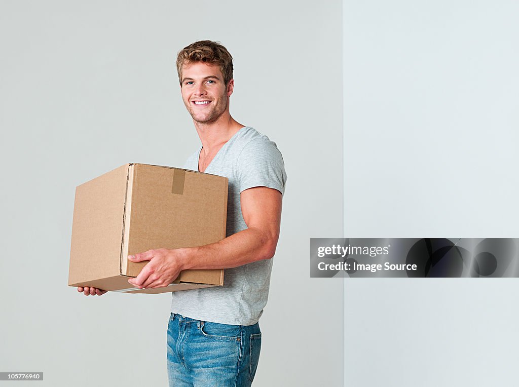 Young man with cardboard box
