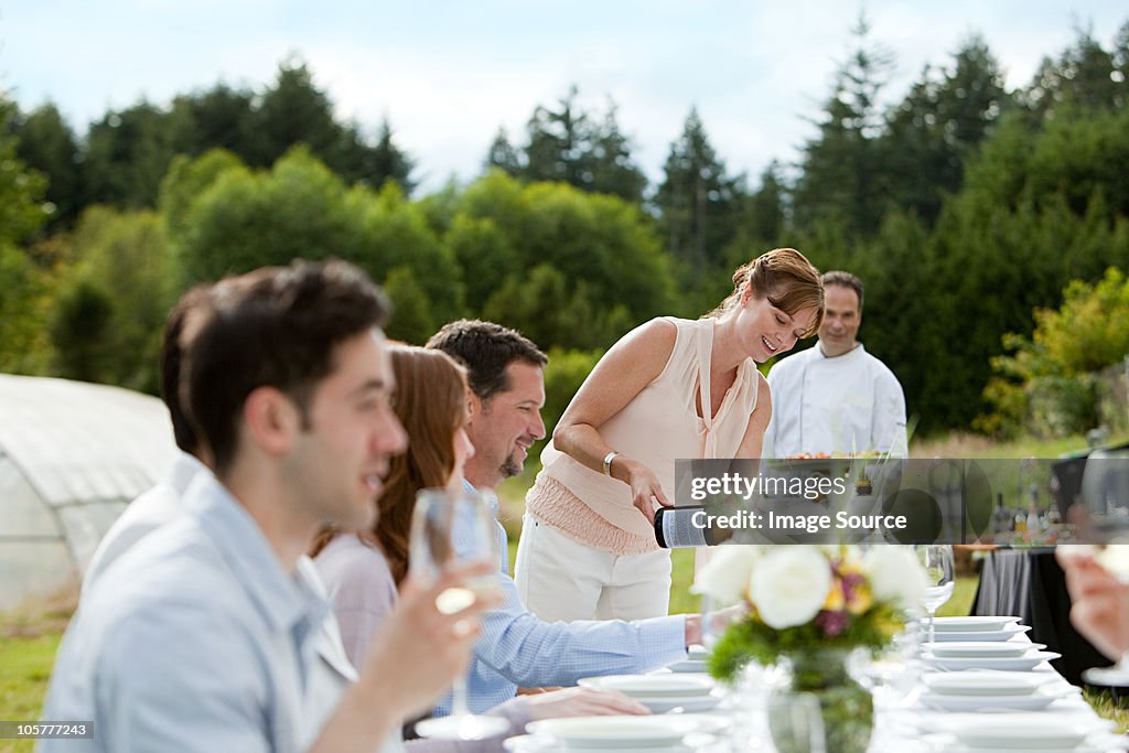 People at dinner party on a farm