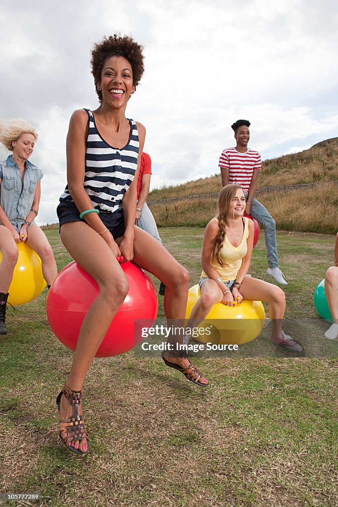 Young people bouncing on hoppity horses