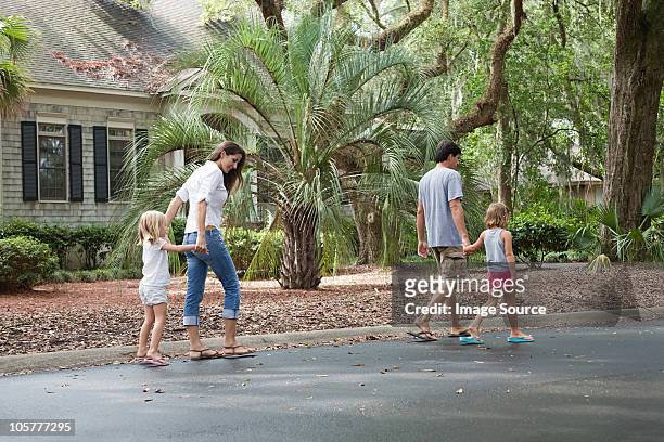 family walking along holding hands - hilton head stock pictures, royalty-free photos & images