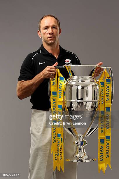 Saracens director of rugby Brendan Venter poses with the Aviva Premiership trophy during the Aviva Premiership Season Launch at Twickenham Stadium on...