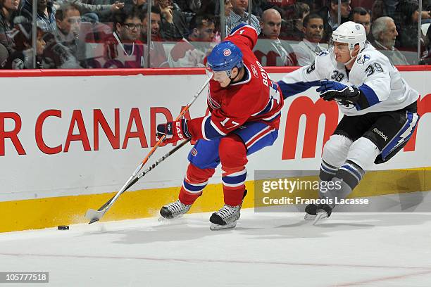 Dustin Boyd of the Montreal Canadiens protects the puck from Mike Lundin of the Tampa Bay Lightning during the NHL game on October 13, 2010 at the...