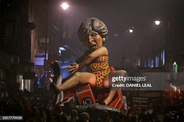 An effigy of Britain's Prime Minister Theresa May paraded through the streets of Lewes in East Sussex, southern England, on November 5 during the...