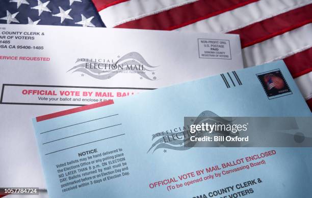 Voting ballot: Absentee voting by mail with ballot envelope on USA flag ...