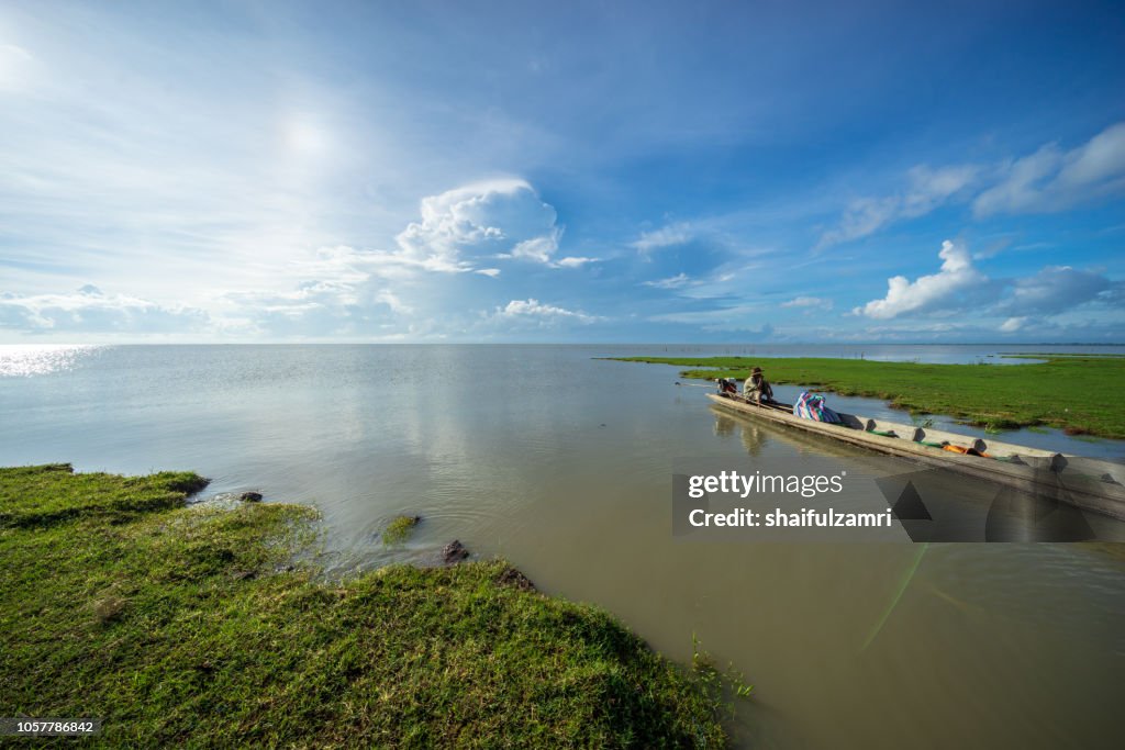 Local fisherman at lake Thale Noi become a part time tourist guide  to travel area surrounding.