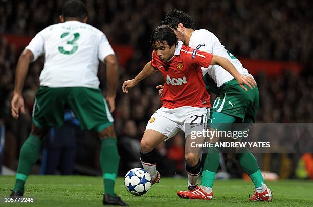 Manchester United's Brazilian defender Rafael Da Silva and Bursaspor manager Ertugrul Saglam compete for the ball during their UEFA Champions League...