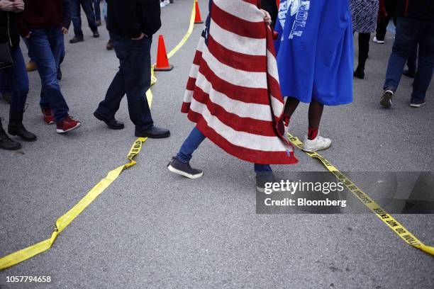 Attendees wait in line outside a campaign rally for Mike Braun, Republican U.S. Senate candidate from Indiana, featuring U.S. President Donald Trump,...