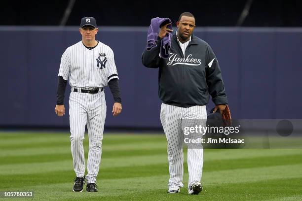 Starting pitcher CC Sabathia and pitching coach Dave Eiland of the New York Yankees walk towards the dugout from the bullpen to play against the...